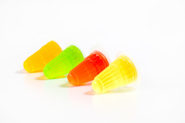 Row of multicolor fruit jelly on white background