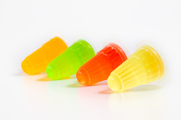 Row of multicolor fruit jelly on white background