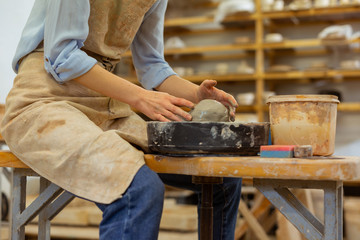 Hard-working lady in blue jeans sitting on a wooden bench