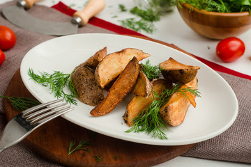 Baked potato wedges with dill. Cafe menu on a wooden background in warm colors with copy space.