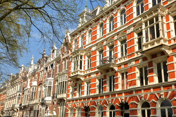 Obraz premium Traditional dutch old facades located on Weesperzijde Street along Amstel river, Amsterdam, Netherlands