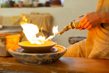 Strong calm man holding special burning tool for baking
