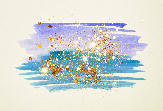 Golden glitter and glittering stars on abstract blue watercolor splash in vintage nostalgic colors.