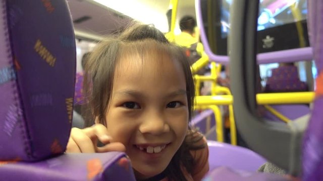Little girl having fun riding on Hong Kong double deck Bus