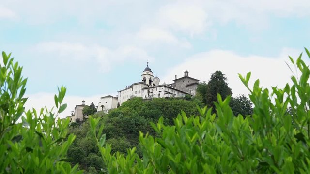 A view from the distance of the Sacred Mountain of Varallo, a christian devotional complex, a unesco world heritage si in Italy. Zoom out 4k footage