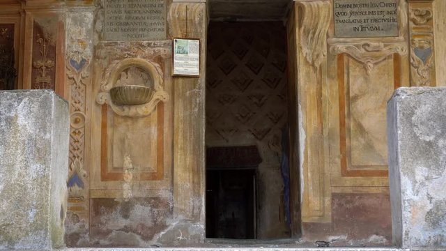 Entrance of Holy Sepulchre at Mountain of Varallo, a christian devotional complex, a unesco world heritage site close to river Sesia near the town of Varallo Sesia in Italy. Zoom in 4k footage