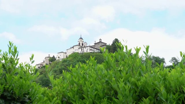 A view from the distance of the Sacred Mountain of Varallo, a christian devotional complex, a unesco world heritage si in Italy. 4k footage