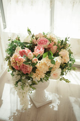   Flower wedding decorations  . Beige sofa and floor vase with flowers classic interior