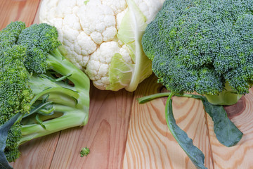 Fragment of broccoli and cauliflower heads on the rustic table