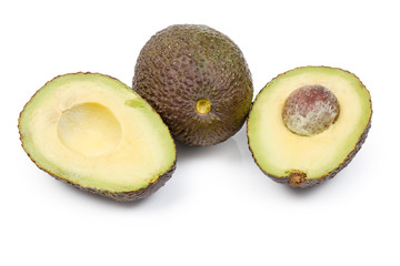 Whole and cut in half brown avocado on white background