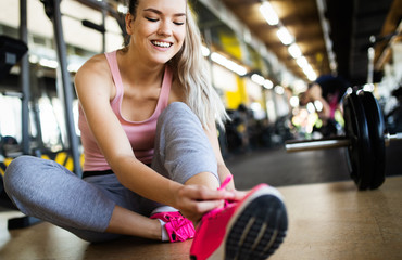 Fototapeta premium Fit sportswoman exercising and training at fitness club