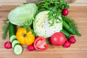 Top view of various fresh vegetables and greens close-up