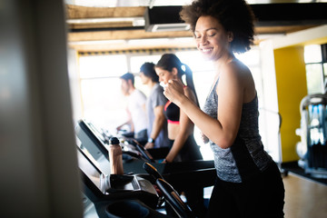 Fototapeta na wymiar Beautiful fit people exercising together in gym