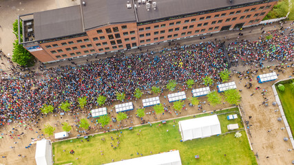 Marathon running race, aerial view of start and finish line with many runners from above, road racing, sport competition, Copenhagen marathon, Denmark