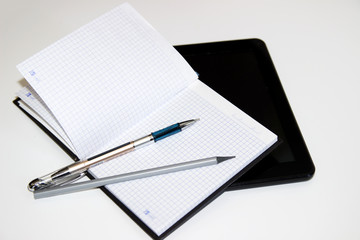 photo tablet, notebook and pen on white background