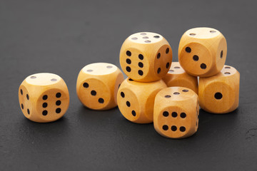Rolling dice on a wooden desk