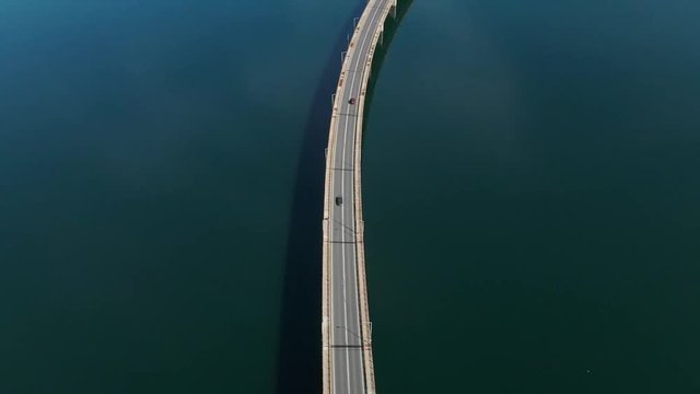 Techniti Limni Polifitou- Traffic on the bridge over Polifitou Lake in Greece. Aerial- tilting up