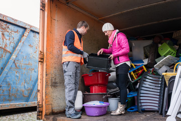 Man and woman in recycling center - obrazy, fototapety, plakaty