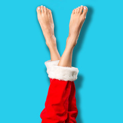 Sexy santa legs over bright blue background