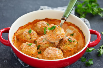Meatballs in a creamy tomato sauce.