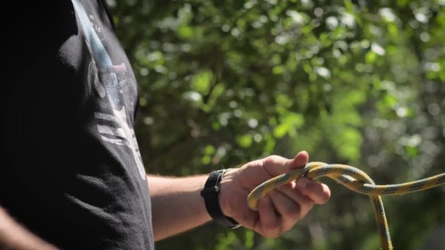 Climber making a knot with the rope