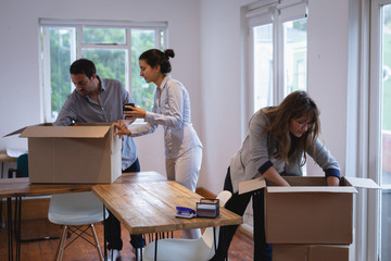 Business people packing cardboard boxes in the office