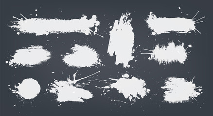set white ink spots set on black background.