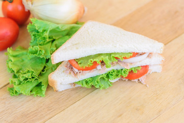 sandwich tuna salad with the ingredients on wood plate