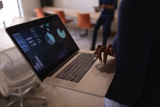 Businesswoman using laptop in office