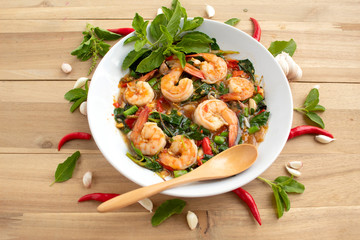Stir fried shrimp basil with red chilli and garlic on wood
