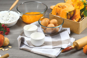 Putting pumpkin puree in the glass bowl. Preparing pumpkin puree. Ingredients for pumpkin pie, recipe, menu