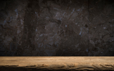 Old wooden table with brick background dark