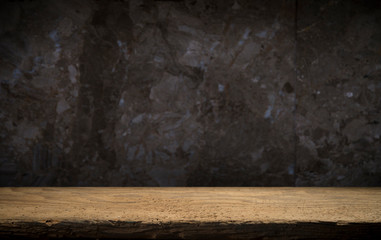 Old wooden table with brick background dark