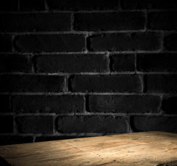 Old wooden table with brick background dark