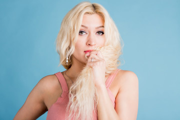 Studio shot of good-looking beautiful woman isolated against studio wall