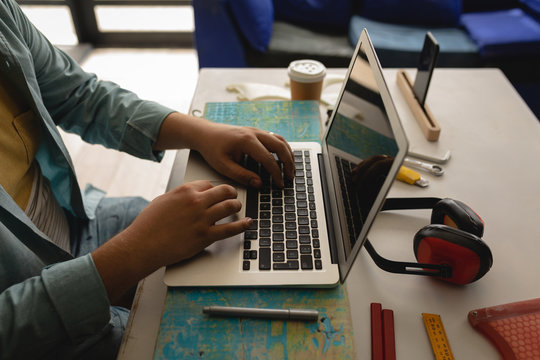 Man using laptop in a workshop