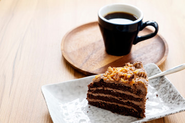 Hot coffee and toffee cake on a wooden table