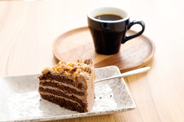 Hot coffee and toffee cake on a wooden table