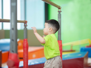 Obraz premium Little toddler boy working out at the indoor gym excercise