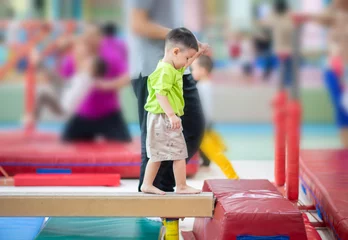 Zelfklevend Fotobehang Little toddler boy working out at the indoor gym excercise © wckiw