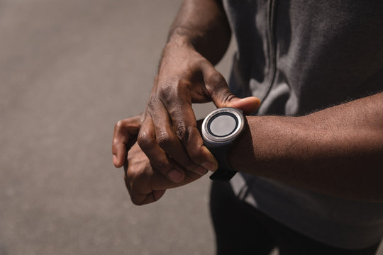 Man looking at smart watch on street 