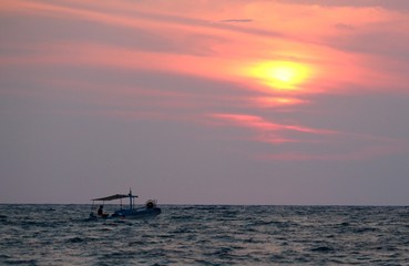 Naklejka na ściany i meble evocative image of fishing boats at sunset