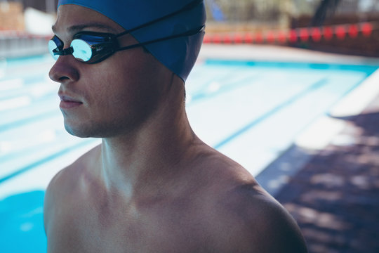 Young Caucasian male swimmer with swim goggle 