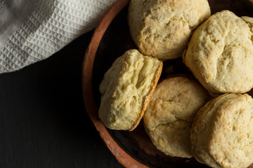 Scones made with buttermilk and flour, close up in earthenware bowl