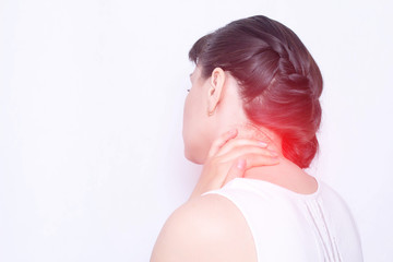 A young girl holds on to a sore neck in which the protrusion and fibromyalgia of the muscles,...