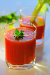 Tomato juice in a glass with a parsley leaf. Healthy organic food concept. Close up. Selective focus.