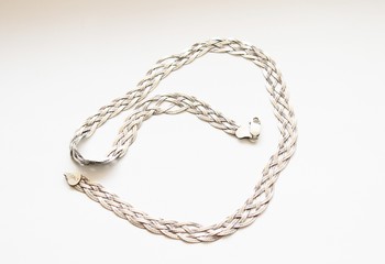 Silver chain located on a white background