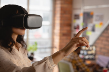 Businesswoman using virtual reality headset in office 