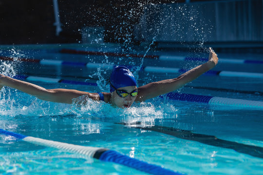 Female Swimmer Swimming Freestyle In Swimming Pool