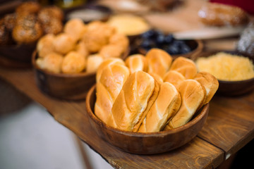 Homemade buns in a beautiful wooden cup.
